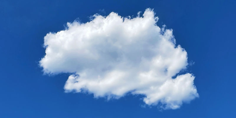 A round fluffy cloud on a deep blue sky.