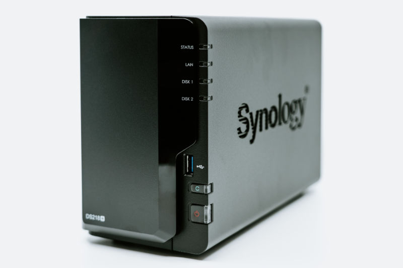 The Synology DS218+ NAS in black on a white background.