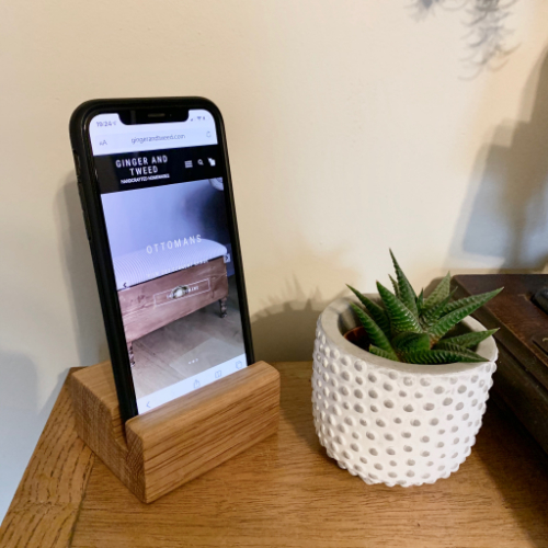 An iPad Pro in the wooden bath tray, set atop a bath.